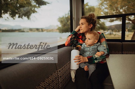 Mother and baby looking out window of motorhome, Wanaka, Taranaki, New Zealand