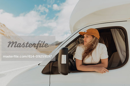 Woman leaning out window of motorhome
