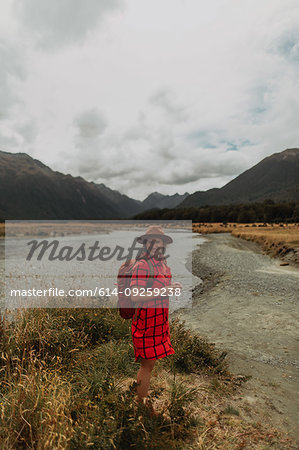 Woman exploring wilderness by lake, Queenstown, Canterbury, New Zealand