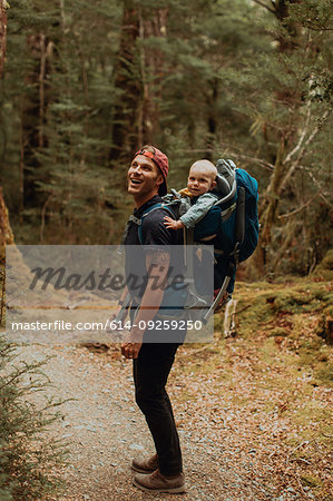 Hiker with baby exploring forest, Queenstown, Canterbury, New Zealand