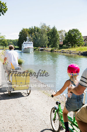 Family cycling by canal