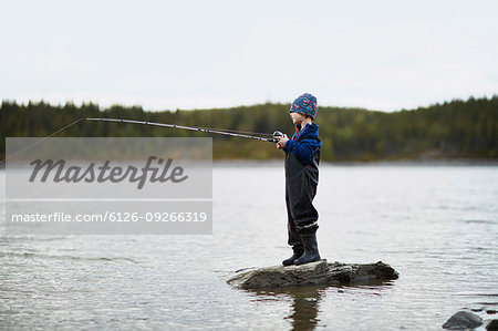 Boy fishing in river