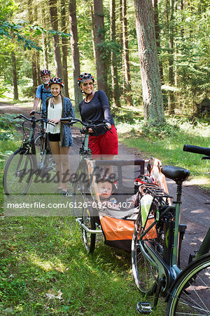 Family with bicycles in forest