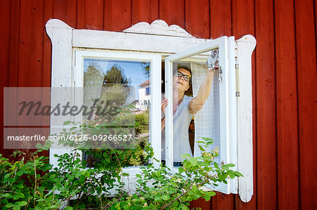 Mature woman cleaning windows