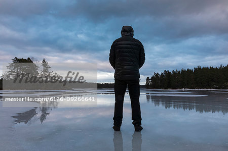 Man standing on frozen lake