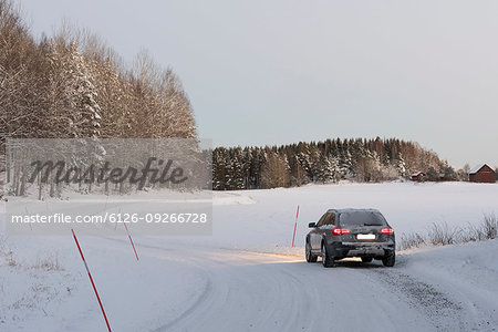 Car driving on snowy rural road