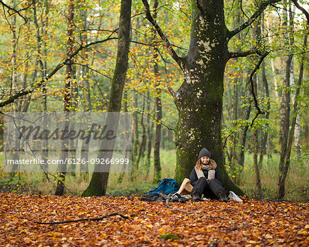 Young woman sitting in forest