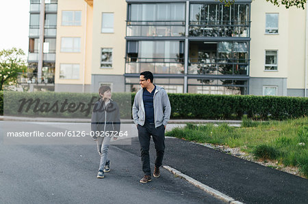 Father and son walking on a city street