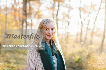 Young woman wearing green scarf in forest