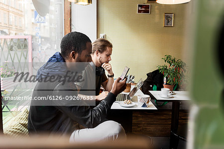 Young men sitting in cafe