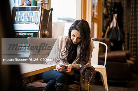Young woman sitting at table in barbershop