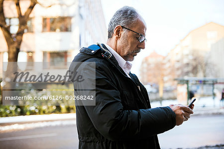 Mature man using smartphone