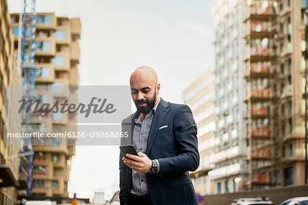 Man using smart phone in city
