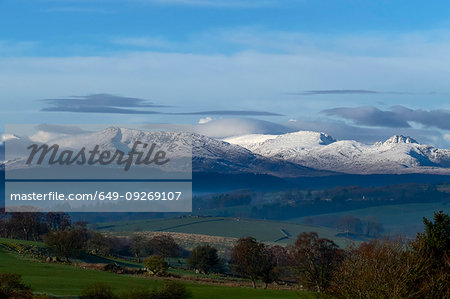 Scenic landscape with distant snow capped mountains, Llanberis, Gwynedd, Wales