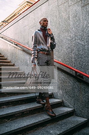 Stylish man going into subway station, Milan, Italy