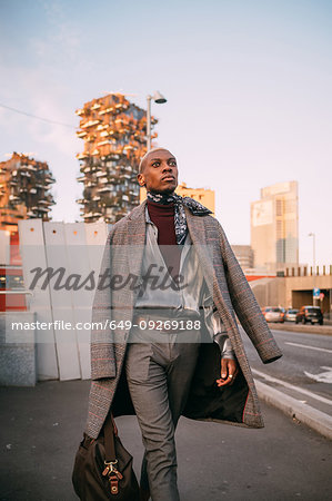 Stylish man walking on street, Milan, Italy