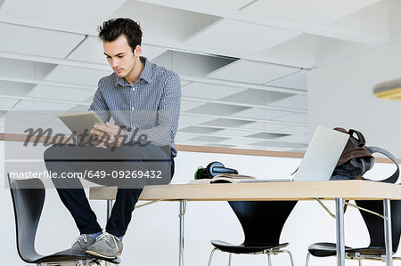 Businessman using digital tablet in office