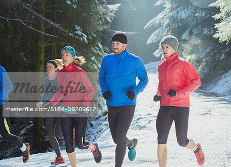 Friends jogging in snow