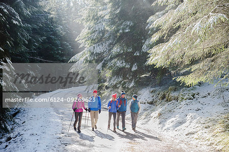 Family hiking in snowy woods
