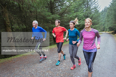 Family jogging in woods