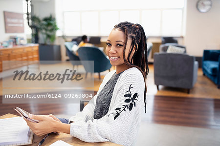 Portrait confident businesswoman with digital tablet in office