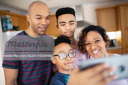Family taking selfie in kitchen