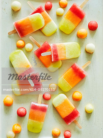 Tri-coloured ice lollies and ice balls on table
