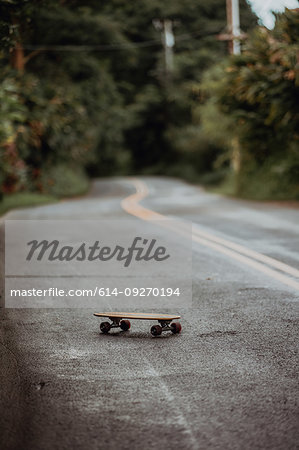 Skateboard on rural road, selective focus, Haiku, Hawaii, USA