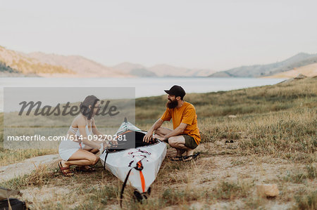 Couple preparing kayak by lake, Kaweah, California, United States