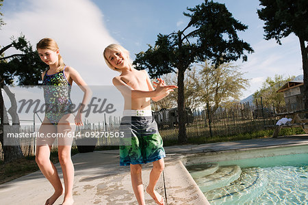 Brother and sister playing by swimming pool, Olancha, California, US