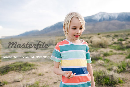 Boy exploring rural landscape, Olancha, California, US