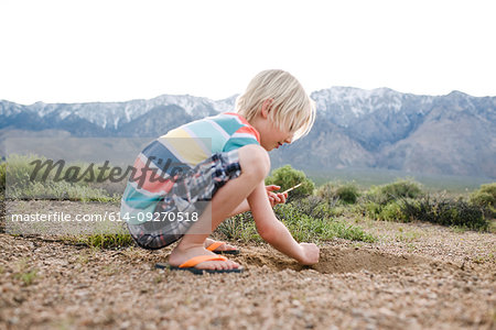 Boy exploring rural landscape, Olancha, California, US