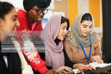 Female college students in hijab and dhuku using computer in computer lab