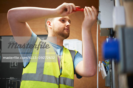 Male electrician student using screwdriver