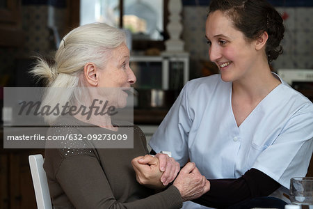 Senior patient talking with nurse