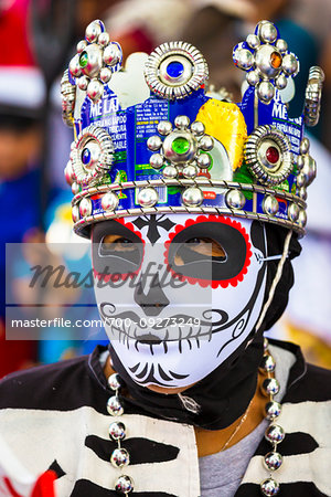 Close-up of an indigenous tribal dancer wearing mask and crown at a St Michael Archangel Festival parade in San Miguel de Allende, Mexico
