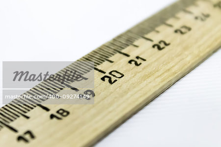 drawing wooden ruler diagonally over white background