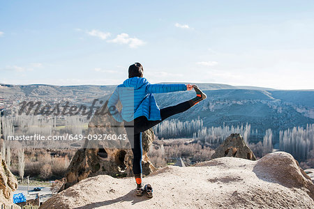 Woman practising yoga in Selime Monastery, Göreme, Cappadocia, Nevsehir, Turkey