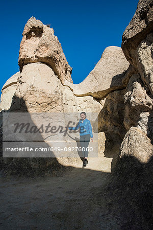 Woman exploring cave, Göreme, Cappadocia, Nevsehir, Turkey