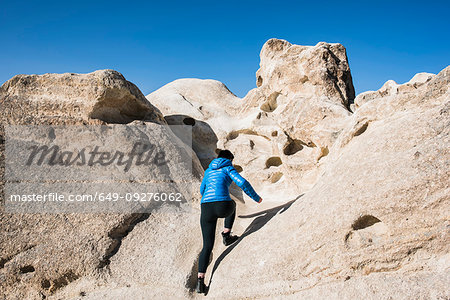 Woman exploring rock formations, Göreme, Cappadocia, Nevsehir, Turkey