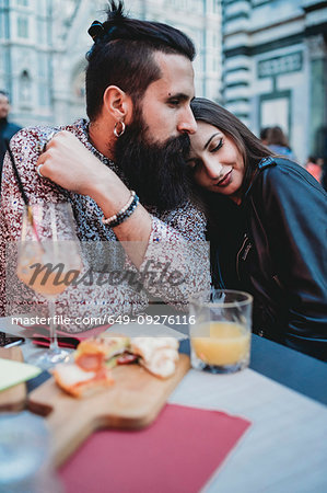 Couple sharing loving moment in cafe