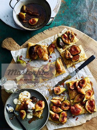 Pieces of figs on crackers served on cutting board