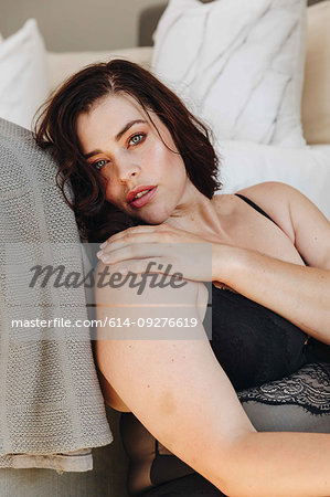 Woman in lingerie posing in bedroom