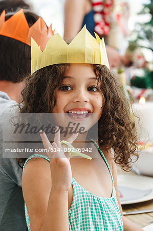 Girl wearing paper crown at home party