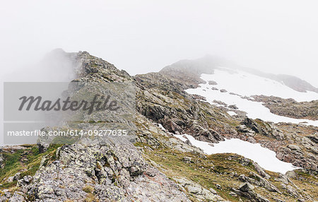 Fog and snow on rocky mountain ranges, Gmund, Tirol, Austria