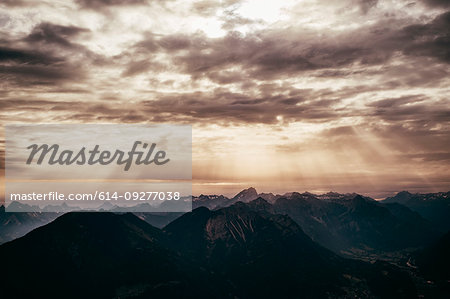 Sun rays shining on mountainscape, Bludenz, Vorarlberg, Austria