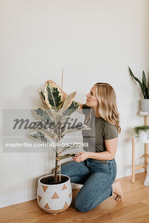 Woman caring for house plant