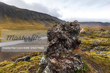 Vehicle driving on road along volcanic lava field, Snaefellsbaer, Vesturland, Iceland