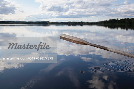 Oar, reflection of cloudscape in lake, Finland