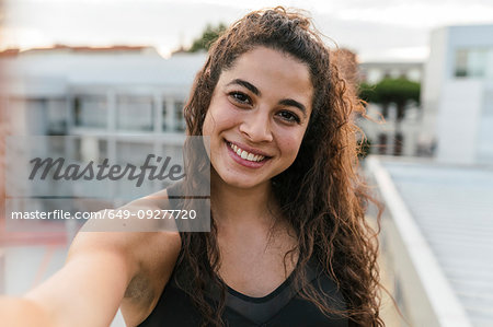 Young woman taking selfie on rooftop deck